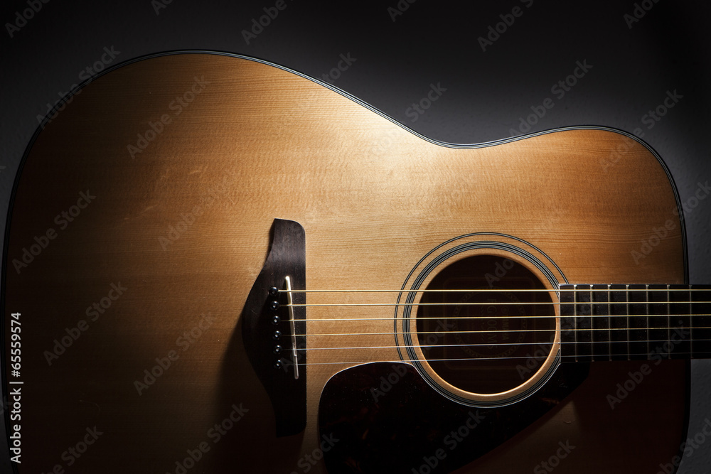 Fototapeta premium acoustic guitar detail on black background