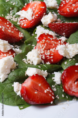 Tasty salad of strawberries, spinach and sesame seeds macro