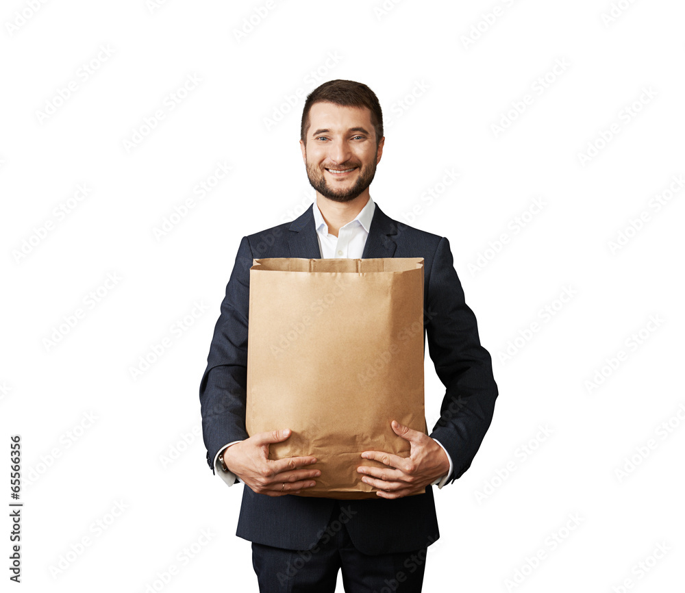 man holding paper bag and smiling man holding paper bag and smiling