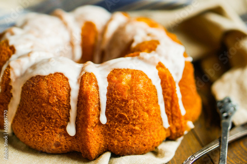 Obraz na płótnie Bundt cake with white glaze on rustic background