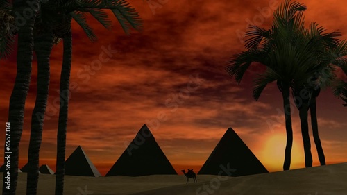 Sunset over pyramids in the dessert photo
