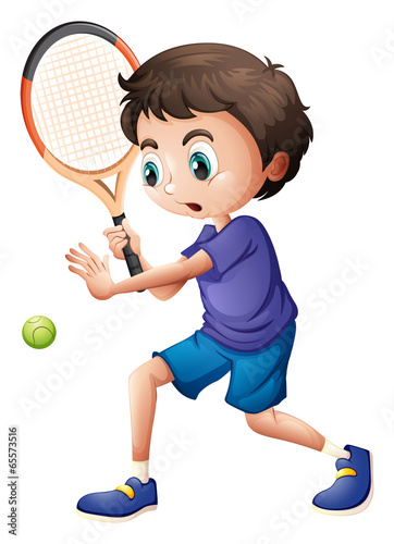 A young boy playing tennis