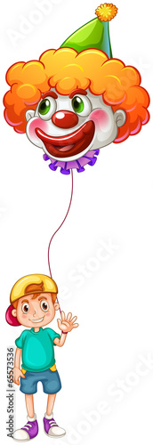 A boy holding a clown balloon