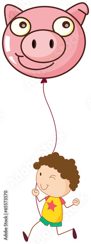 A boy holding a pig balloon