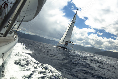 Sailing yachts in the sea at race in stormy weather. © De Visu