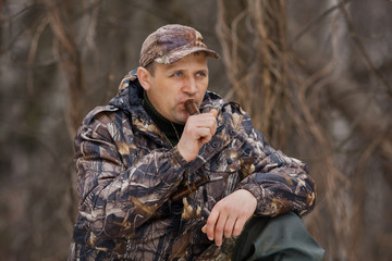 duck hunter with a wooden duck call