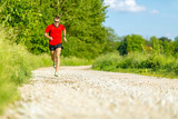 Man trail running on country road