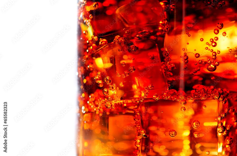 Cola with ice and bubbles in glass closeup Cola with ice and bubbles in glass closeup
