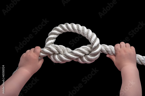 Baby hands holding overhand knot photo