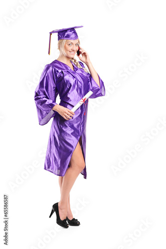 Woman in graduation gown talking on the phone