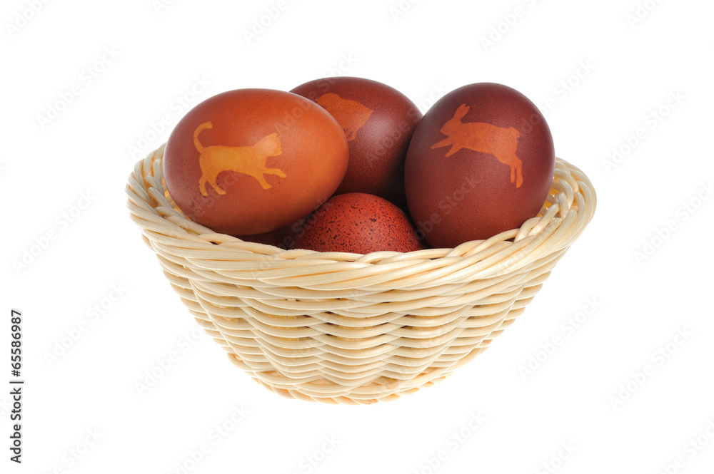 Decorated easter eggs in wicker basket isolated Decorated easter eggs in wicker basket isolated