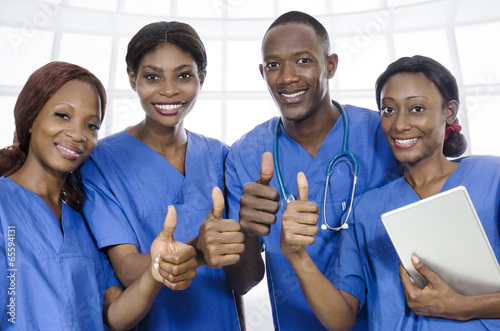 African physician team thumbs up