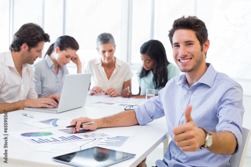 Attractive businessman smiling in the workplace Attractive businessman smiling in the workplace