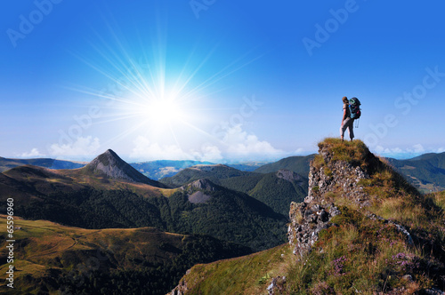 hiker on top of a rock looking far away