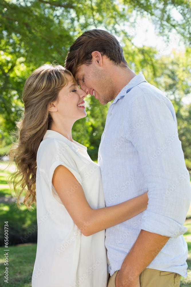 Cute couple hugging and smiling in the park Cute couple hugging and smiling in the park