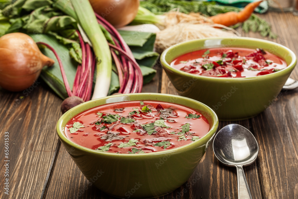 Beetroot soup with fresh vegetables in a bowl