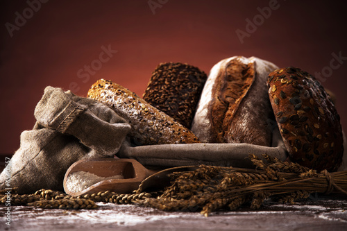 Fresh bread and wheat on the wooden table