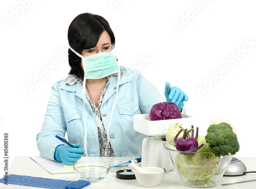 Inspector weighing a red cabbage in laboratory photo