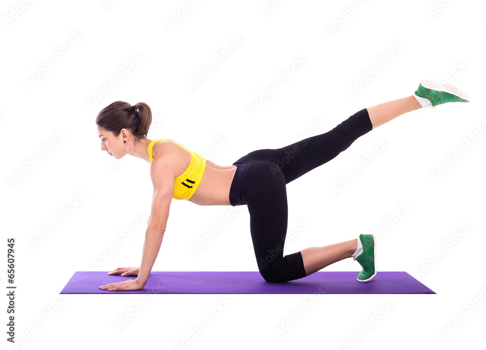 Fitness woman doing stretching exercises on foam pad Fitness woman doing stretching exercises on foam pad
