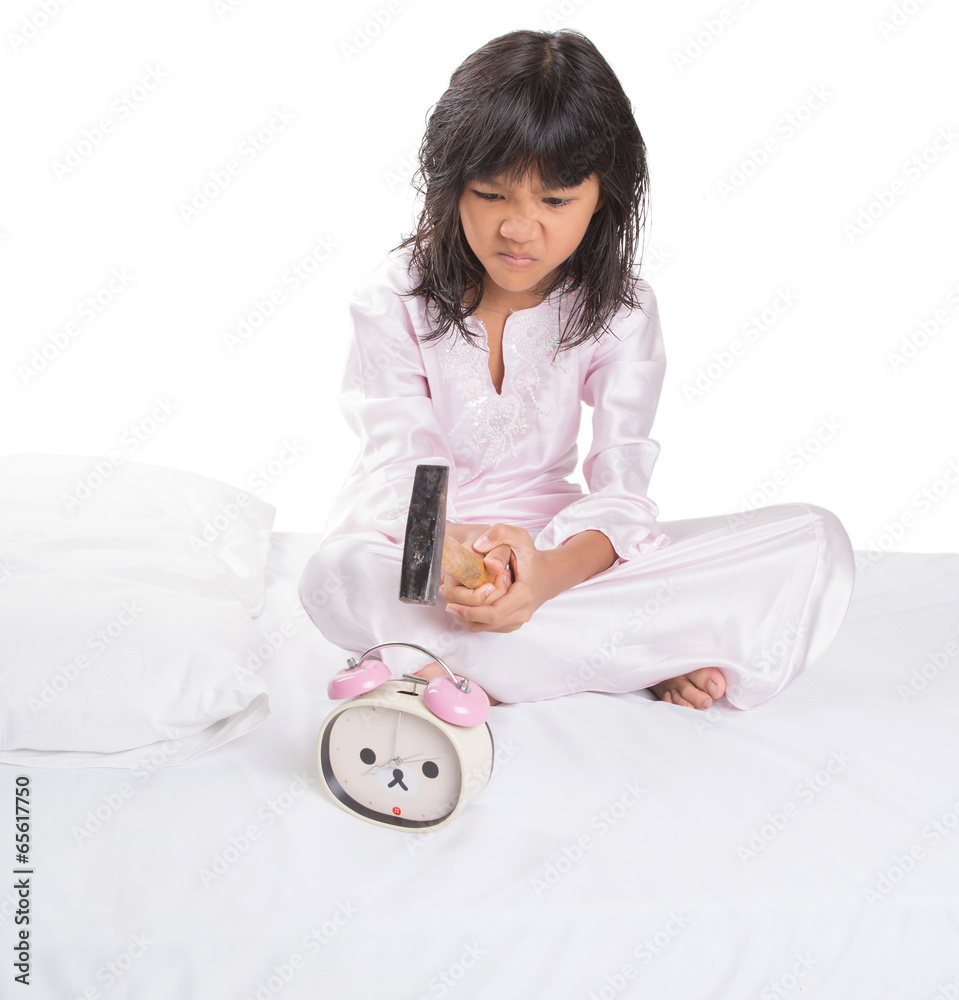 Irritated young girl waking up from sleep and destroy clock Irritated young girl waking up from sleep and destroy clock