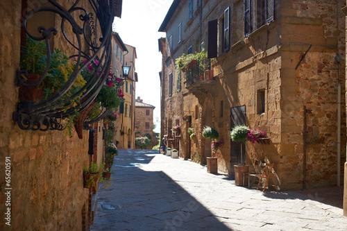Vintage street decorated with flowers, Tuscany, Italy