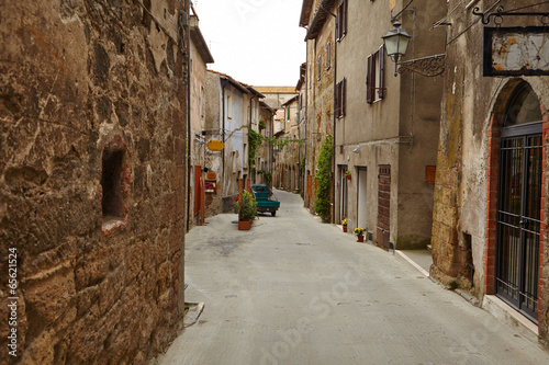 Fototapeta Naklejka Na Ścianę i Meble -  Vintage street decorated with flowers, Tuscany, Italy