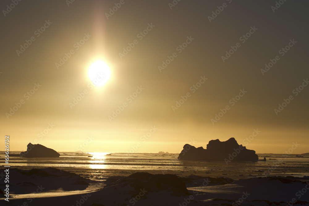 Antarctic icebergs and frozen ocean at sunset 1
