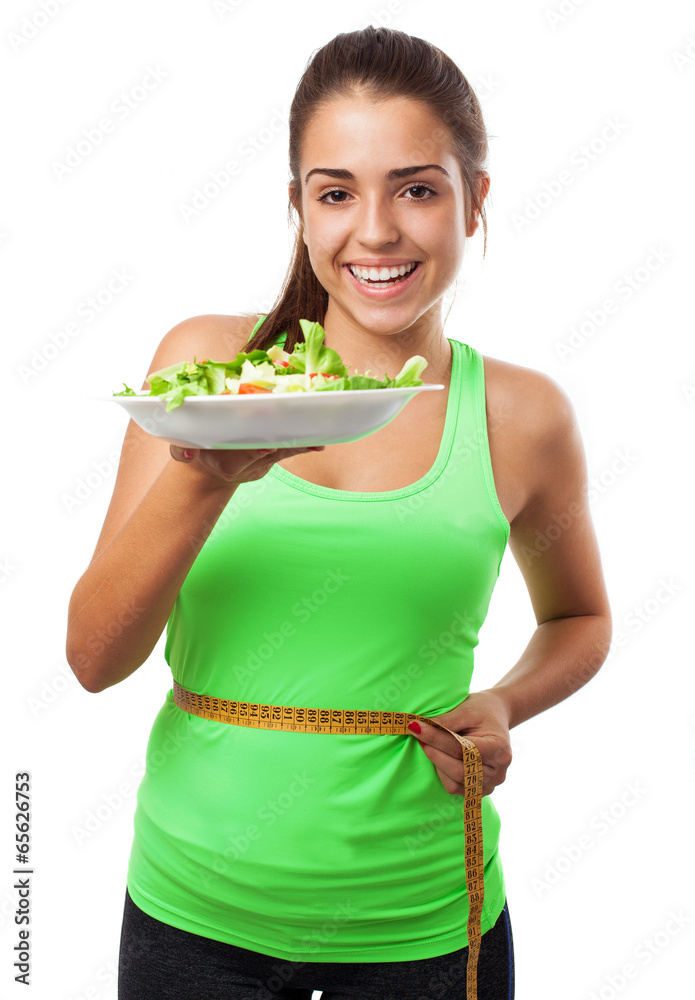 young sporty woman measuring herself and holding a salad on whit young sporty woman measuring herself and holding a salad on whit