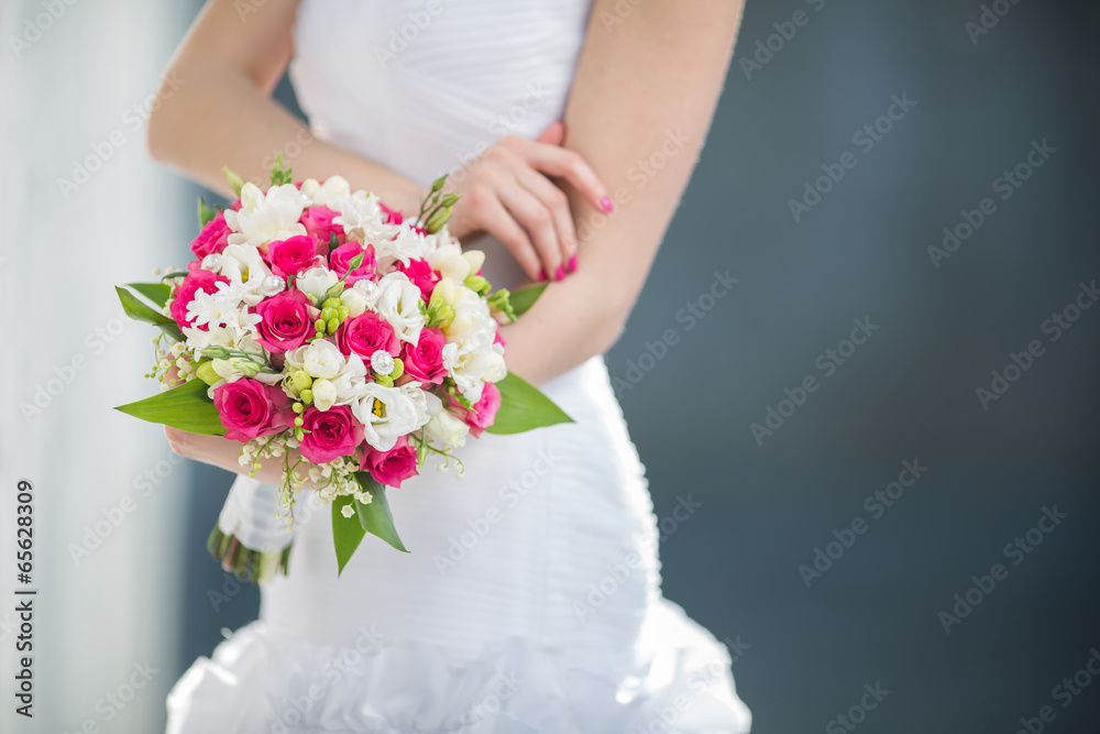 Beautiful wedding bouquet in hands of the bride