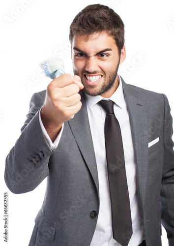 portrait of angry young business man holding an euro banknote on