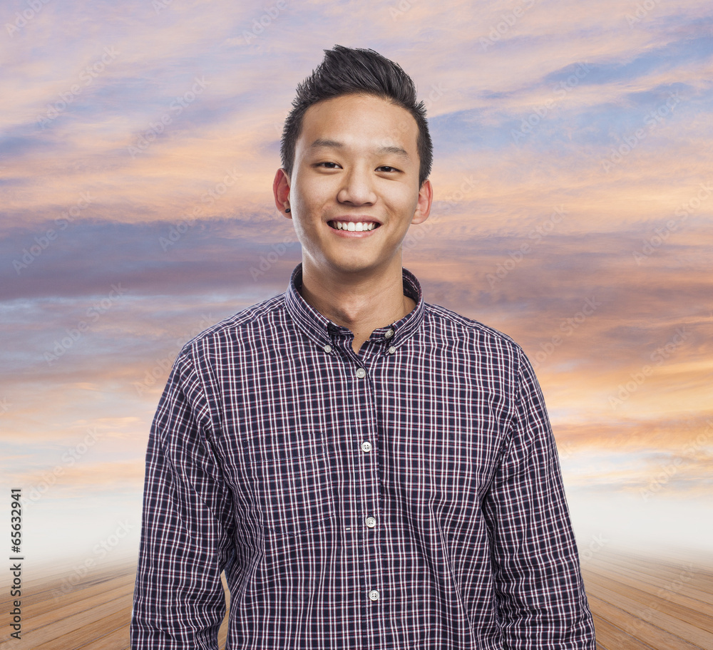 Handsome young asian man smiling wearing a plaid shirt Handsome young asian man smiling wearing a plaid shirt