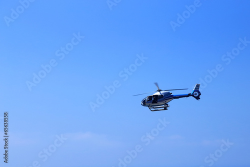 Helicopter flying against the blue background sky