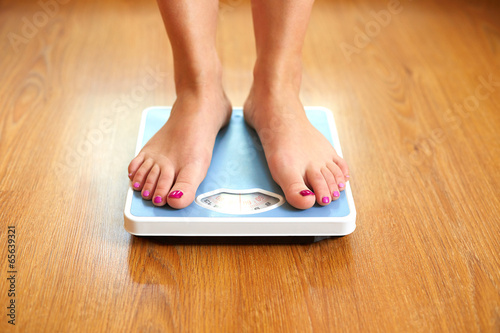 Female bare feet with weight scale