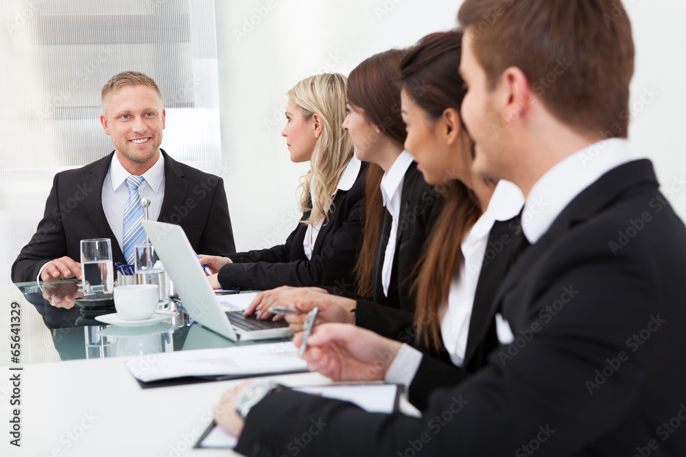 Businessman Looking At Colleagues In Meeting Businessman Looking At Colleagues In Meeting