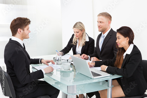 Business Colleagues Working At Desk