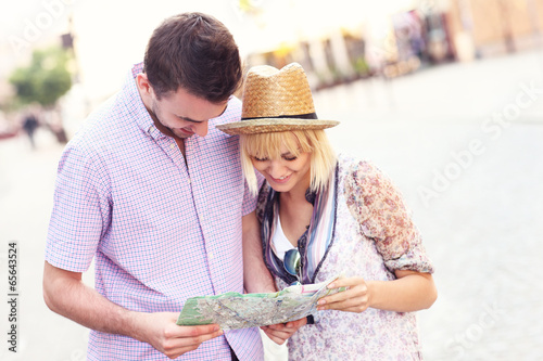 Happy tourists with a map