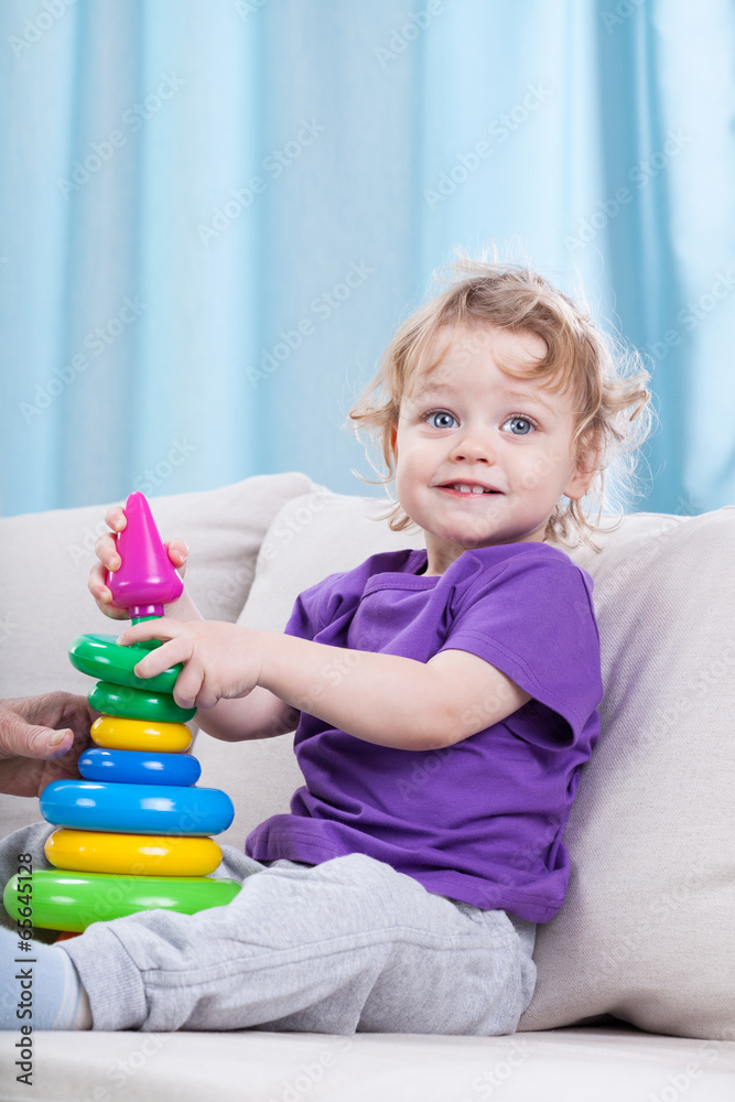 Naklejka premium Little child playing with toys