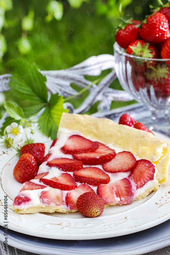 Strawberry cake on wooden tray in summer garden Strawberry cake on wooden tray in summer garden