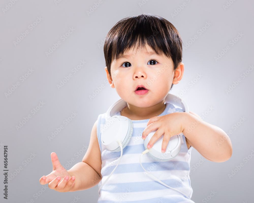 Baby with headphone on shoulder