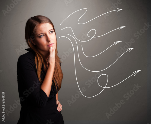 Attractive teenager looking at multiple curly arrows