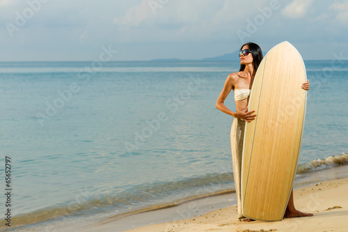 Asian model hodilng a surfboard photo