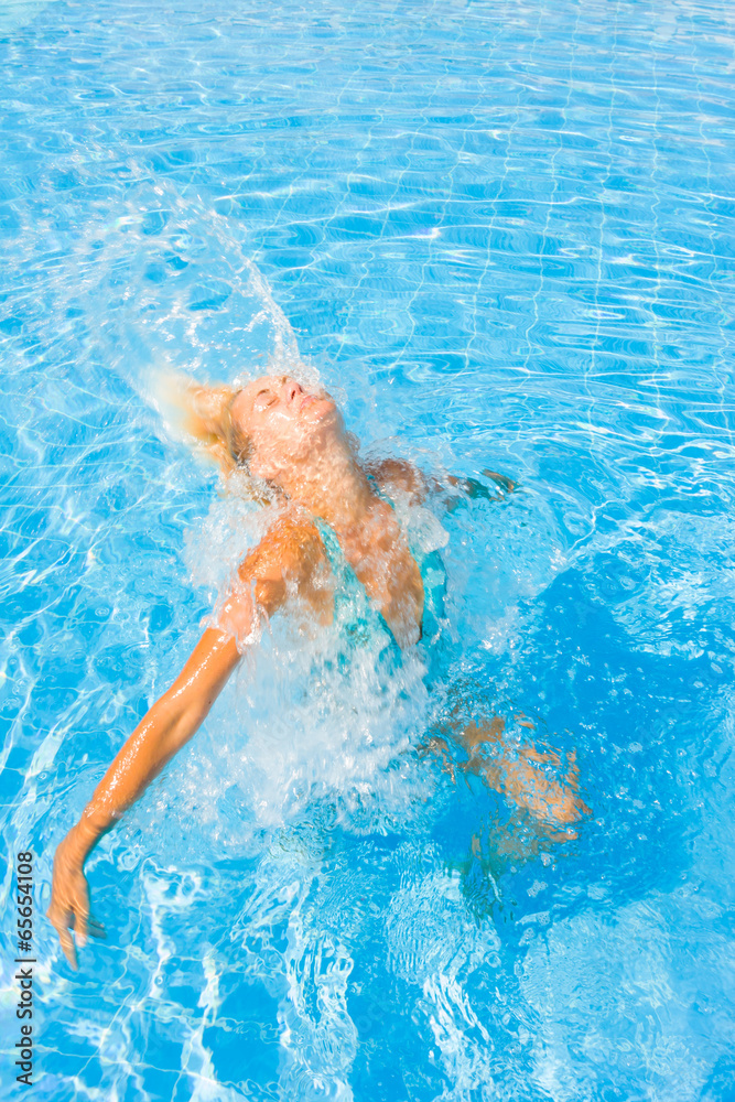 Woman enjoying the summer at the swimming pool