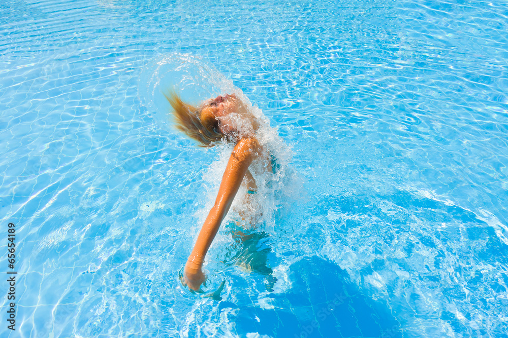 Woman enjoying the summer at the swimming pool