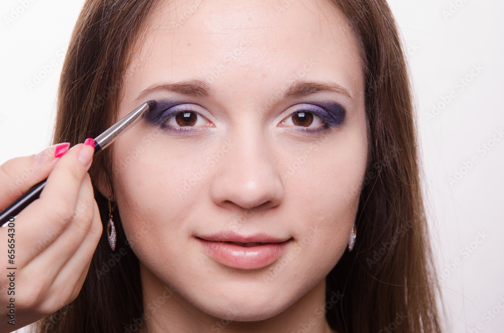 Makeup artist paints a model ever