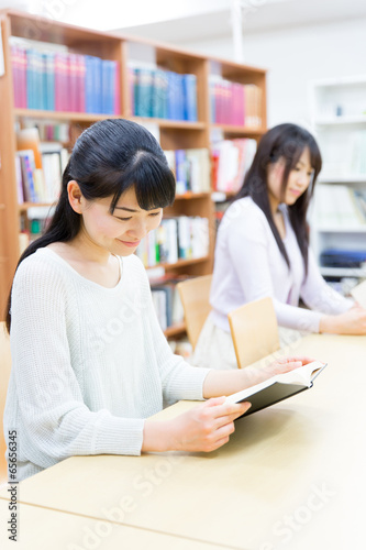 young asian women reading a book in the library