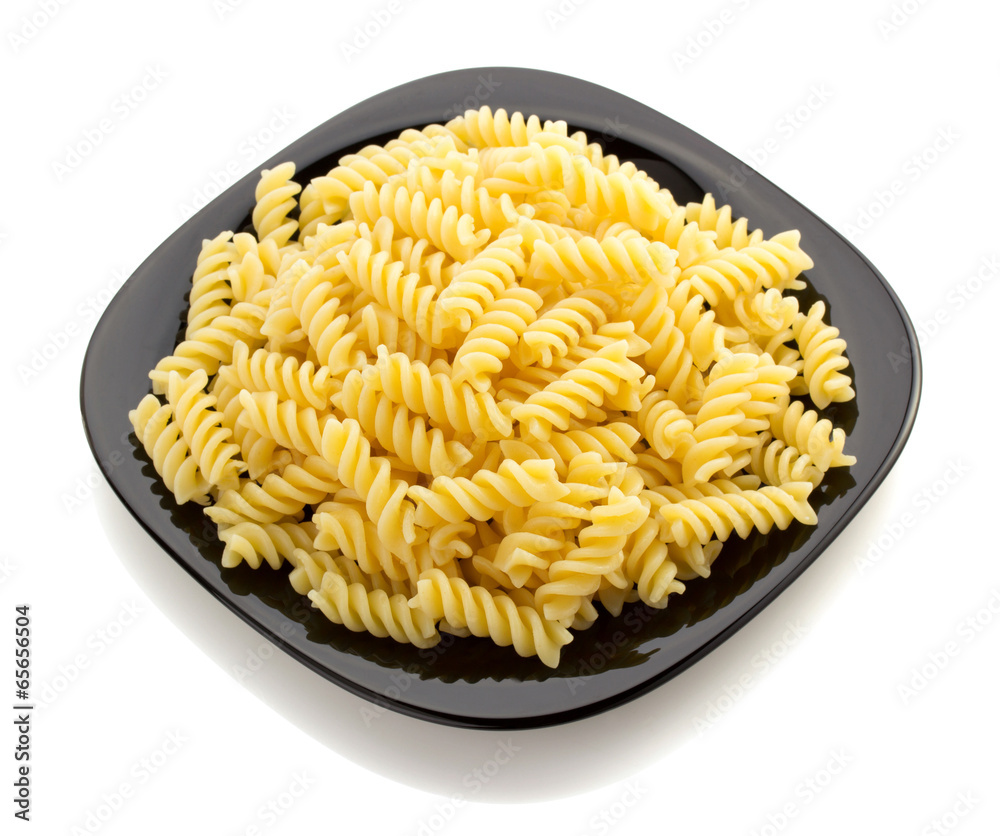 pasta fusilli in plate on white pasta fusilli in plate on white
