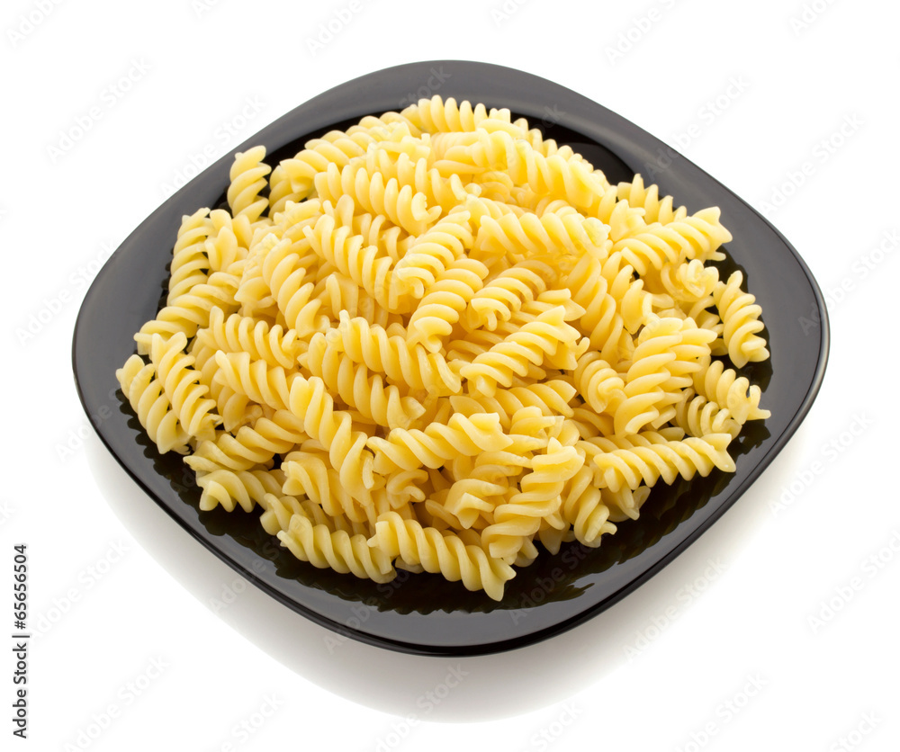 pasta fusilli in plate on white