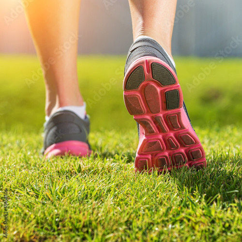 Women's running legs, pink-gray sports shoe detail