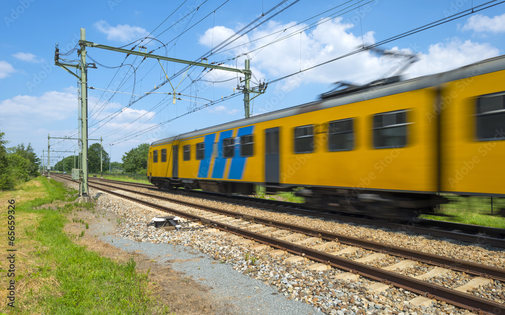 Train riding through the countryside in spring