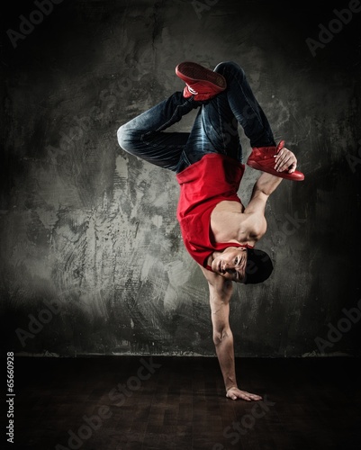 Man dancer showing break-dancing moves photo